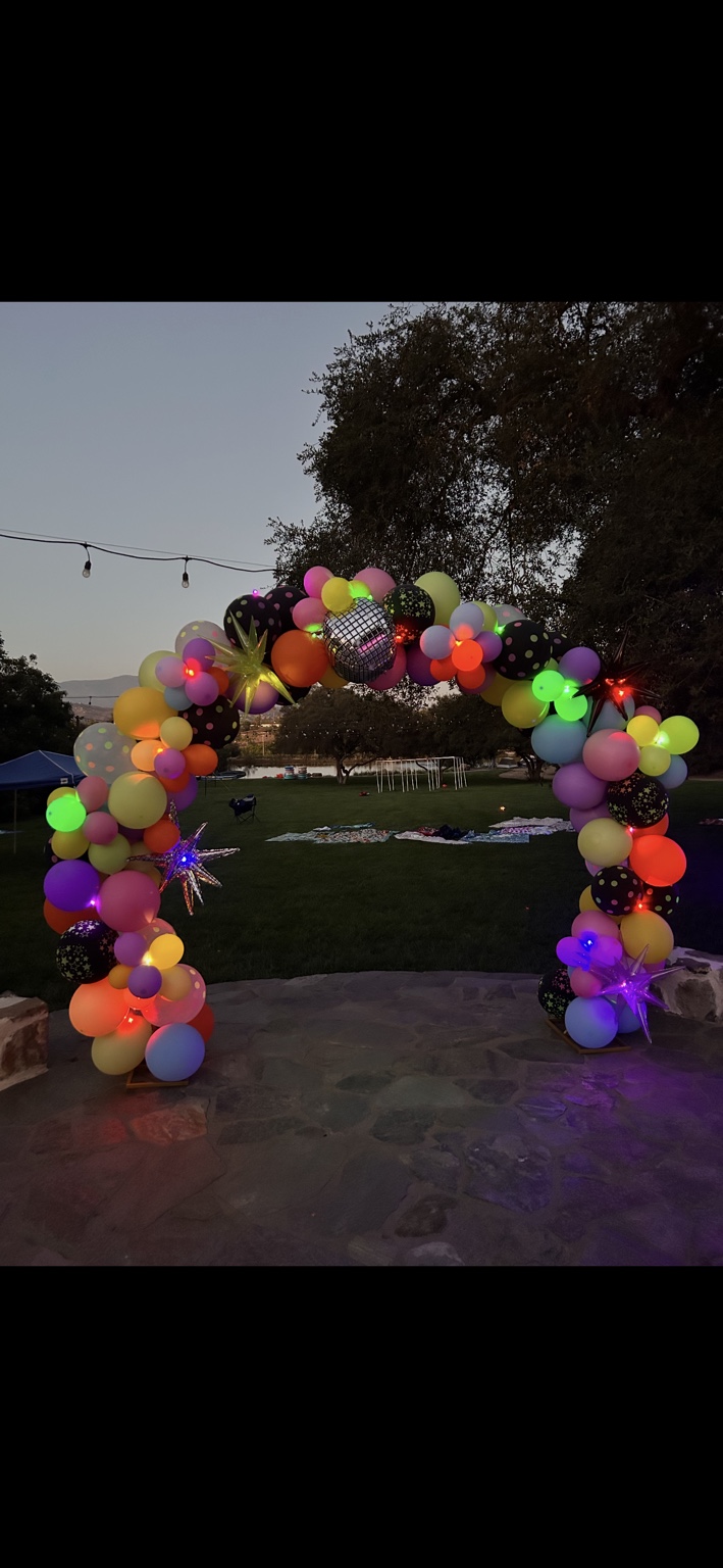 Illuminated evening balloon arch
