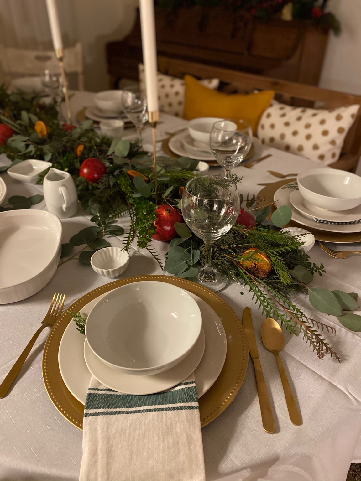 Holiday greenery and pomegranate tablescape