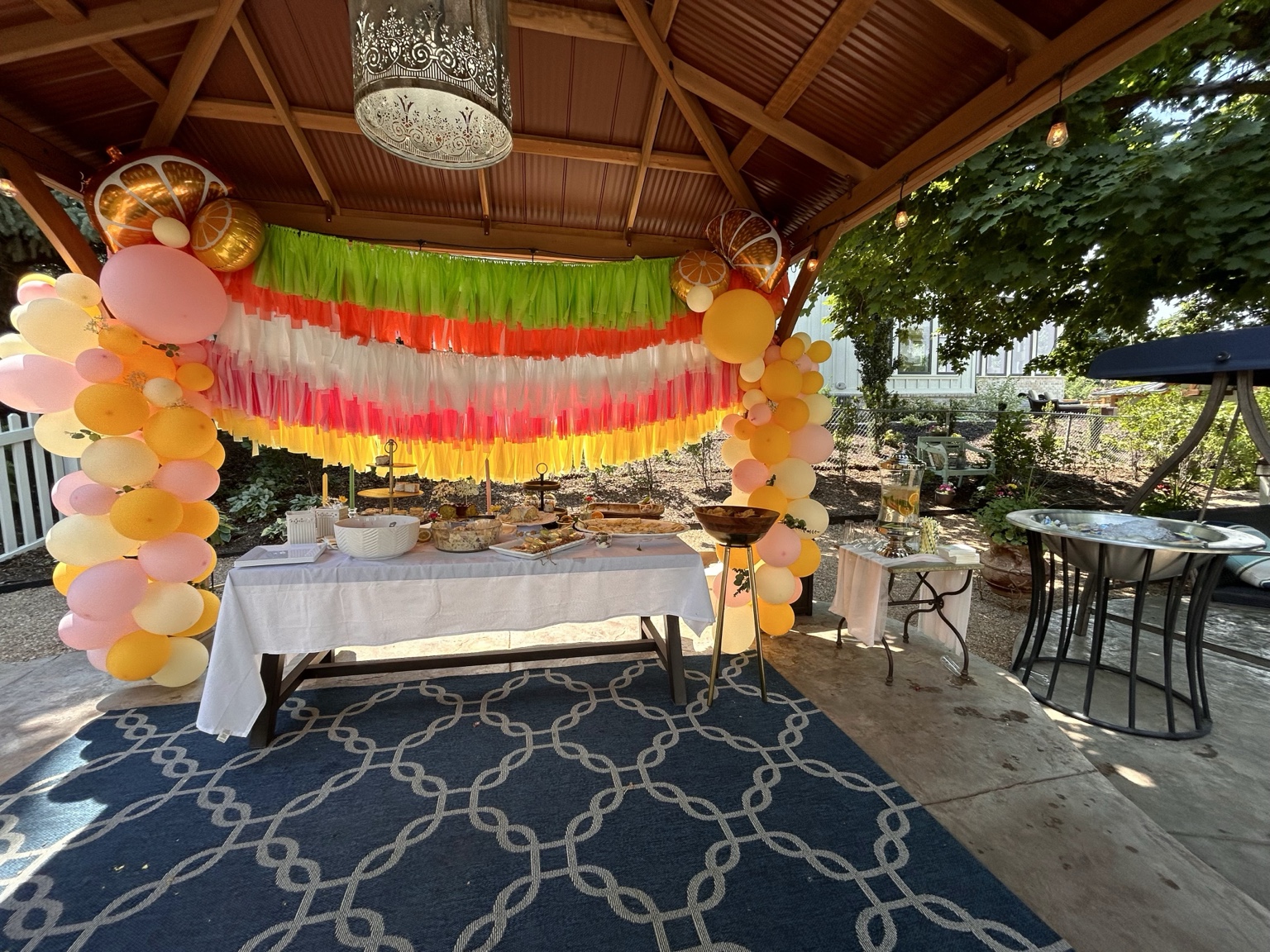 Citrus-inspired balloon and fringe backdrop